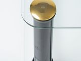 a close up of a glass table with a gold plate on top