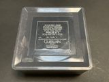 a silver plate with a picture on it on a table