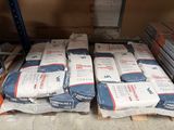 many bags of cement sitting on top of a pallet