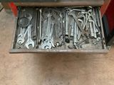 a drawer full of tools sitting on the floor