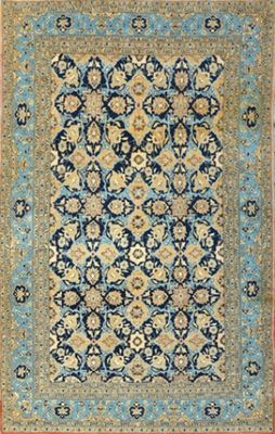 a blue and yellow rug with a medallion design on it