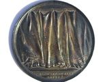 an image of a medal with a curtain on it