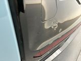 a close up of a car door with a hole in it