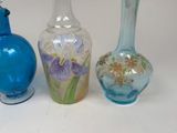three glass vases sitting next to each other on a table