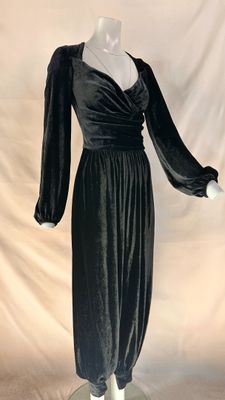 a black velvet dress with long sleeves on a mannequin base