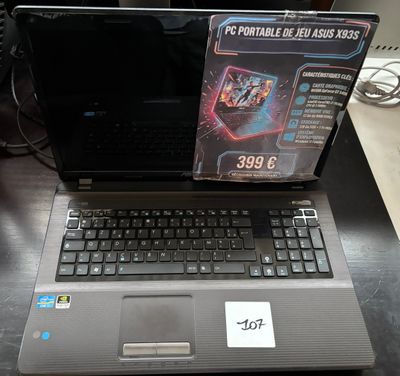 a laptop computer sitting on a table with a box on top of it