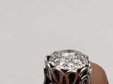 a person holding a diamond ring in their hand