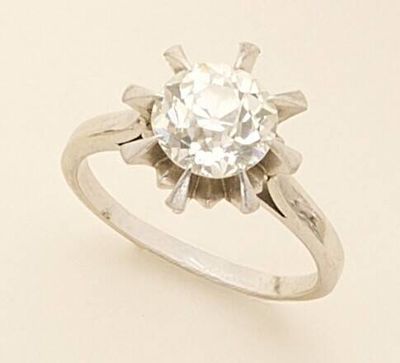 a ring with a diamond on it sitting on a table