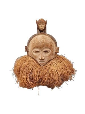 an image of a wooden mask with a man ' s face on top of it