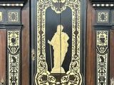 a black and gold door with a picture of a man on it