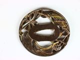 a small circular metal object with a design on it