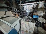 a pile of junk in a garage with a lot of items
