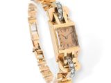 an image of a women ' s watch with diamonds on a gold bracelet