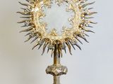 an image of a silver and gold chalicet with a cross on it