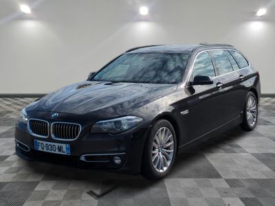 a picture of a black bmw wagon parked in a garage