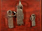 three pieces of metal on a wooden surface