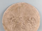 une photo d'une plaque ornée d'une croix, fixée au mur