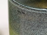 a close up of a cup on a table next to a cell phone