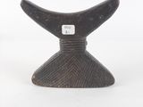 an image of a small wooden whale fin on a white background
