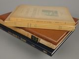 three books stacked on top of each other on a table