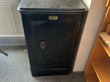 a small black cabinet in the corner of a room