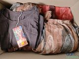 a cardboard box filled with clothes and a tag