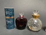 three different bottles of perfume sitting next to each other on a table