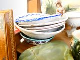 a lot of plates and bowls on the table