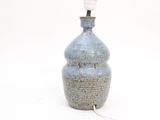 a blue vase with a white light on top of it