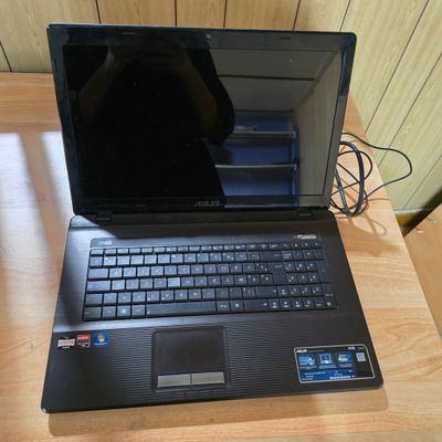 a laptop computer that is sitting on a wooden table