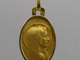 a close up of a gold coin with a woman ' s face on it