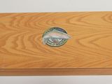 an image of a wooden box with a fish emblem on it