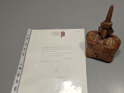 a piece of paper and a statue on a table