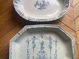 pair of blue and white plates on a wooden floor