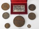 an assortment of coins including a medal, a medal and a medal case