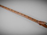 an old wooden instrument with a long neck and a wooden handle