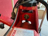 a close up of a red machine with a label on it