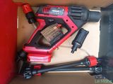 a cordless drill in a box with other tools