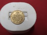 a gold coin sitting on top of a white box