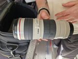 a person holding a camera lens in a bag