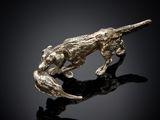 a close up of a sculpture of a dog on a black surface