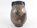 a brown vase with a painting of a man and a woman on it