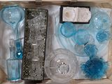 a wooden box filled with assorted glass items