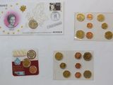 a lot of coins and a postcard on a table