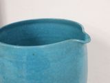 a blue pitcher that is sitting on a table