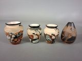 three vases are sitting side by side on a gray surface