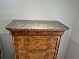 a marble top cabinet in the corner of a room