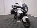 a motorcycle that is parked in a room with a checkered floor