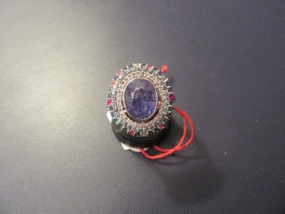 a picture of a broochle with a purple stone in it