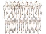 a group of silver spoons and forks on a white background